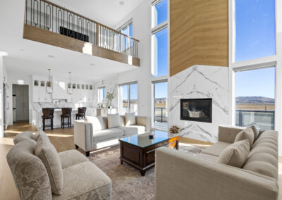 Image of a spacious modern living room in a Calgary luxury home with floor-to-ceiling windows and plush furnishings